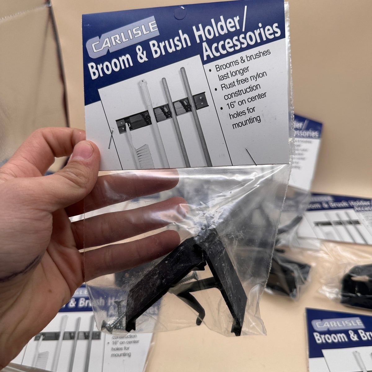 Set of 12 Carlisle 4073300 Roll 'N Grip Plastic Broom Holder Wall Mount, 1.75"