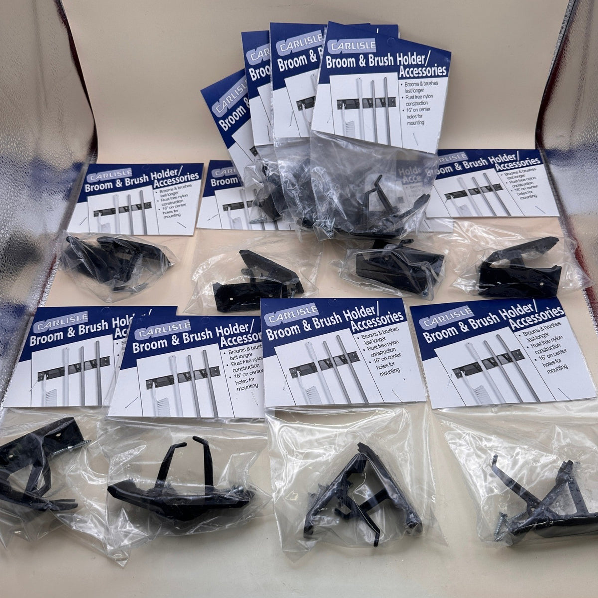 Set of 12 Carlisle 4073300 Roll 'N Grip Plastic Broom Holder Wall Mount, 1.75"